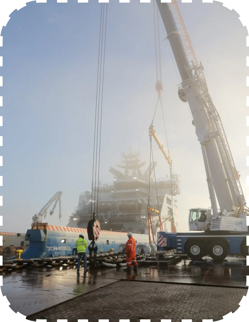 Large view of crane in action with personnel on site