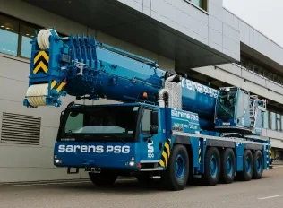 Mobile crane parked in an industrial setting