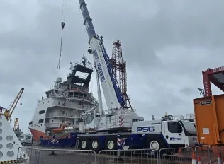Crane in city environment lifting load