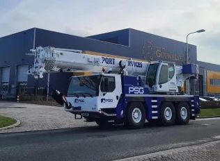 Mobile crane lifting materials on site