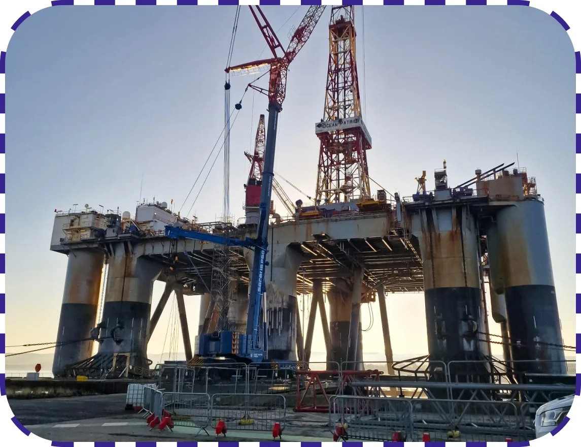 Offshore oil platform with crane operating during daylight