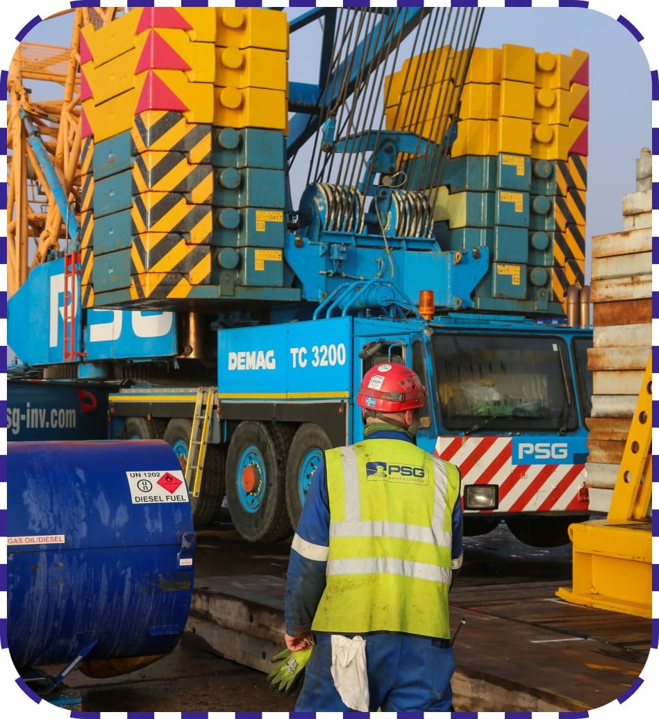 Wind turbines at sea with cargo ship showcasing renewable energy work