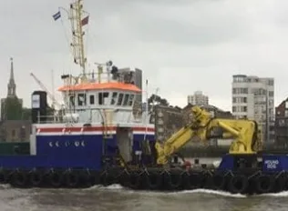Large port vessel being loaded at dockside
