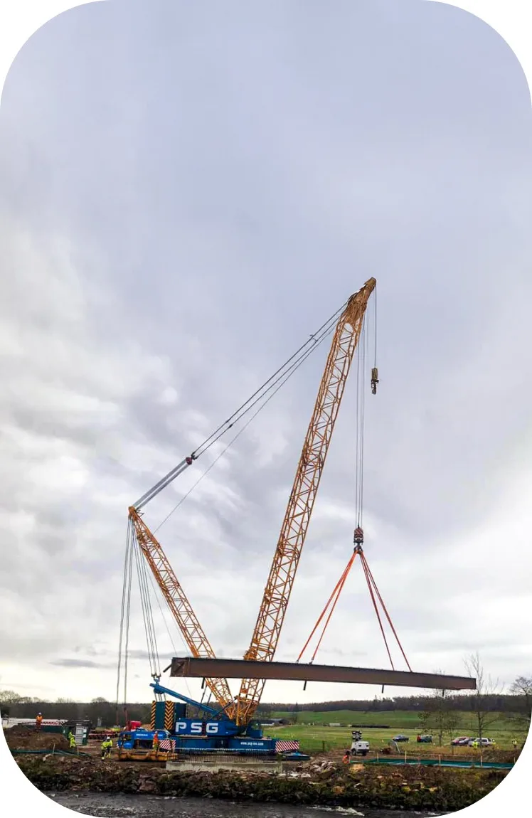 Crane and crew managing rigging service on industrial site