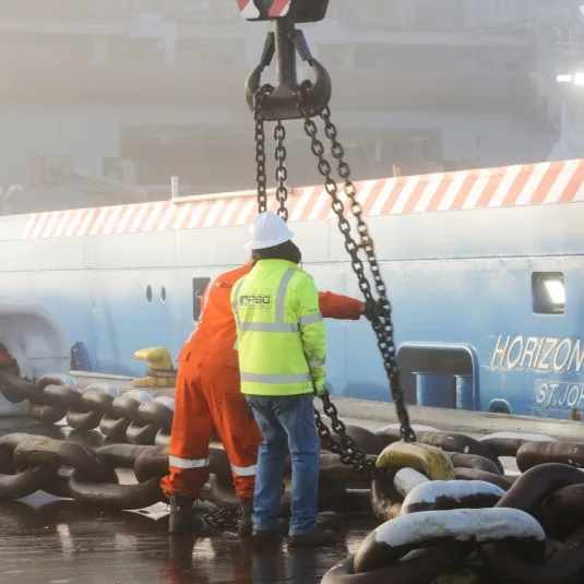 Support crane performing precision rigging operation at port
