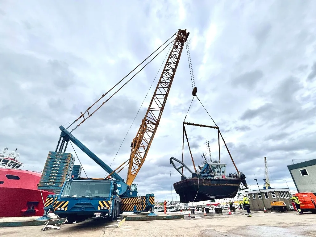 Crane lifting vessel from water